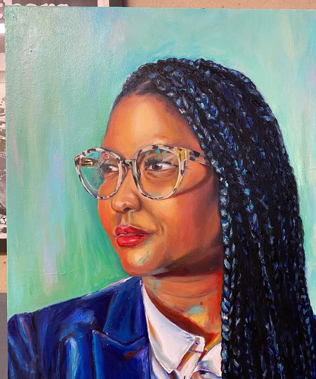 Portrait of a woman with braids and glasses